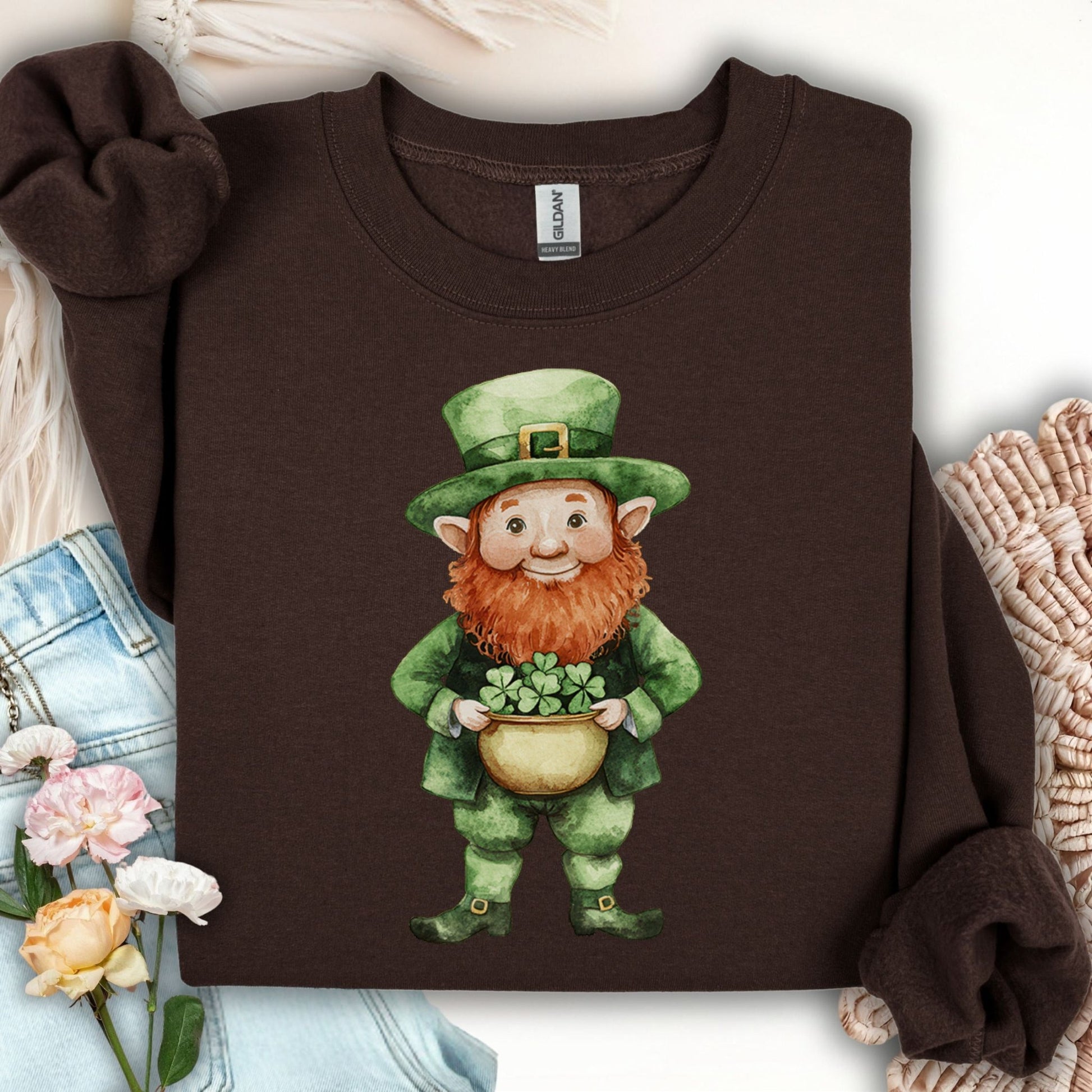 Dark chocolate unisex sweatshirt with a watercolor leprechaun holding a pot of four-leaf clovers.