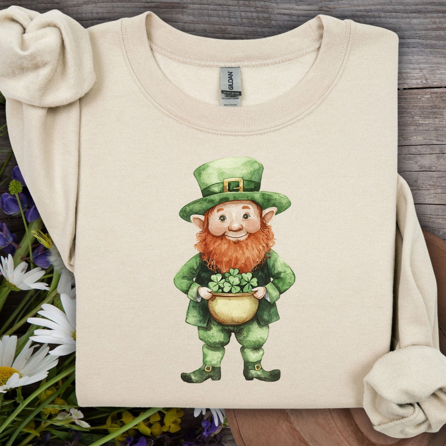 Sand unisex sweatshirt with a friendly leprechaun holding a pot of clovers, perfect for St. Patrick's Day.