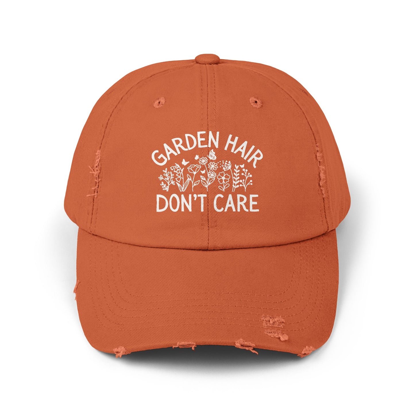 Burnt orange distressed cotton twill cap with "Garden Hair Don't Care" text and floral design.
