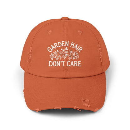Burnt orange distressed cotton twill cap with "Garden Hair Don't Care" text and floral design.