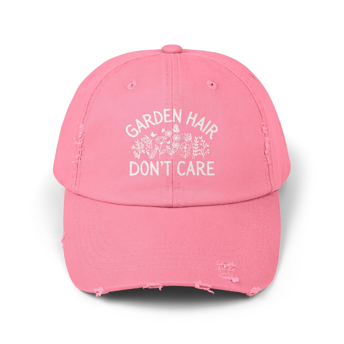 True Pink distressed cotton twill "Garden Hair Don't Care" cap with white text and floral design.