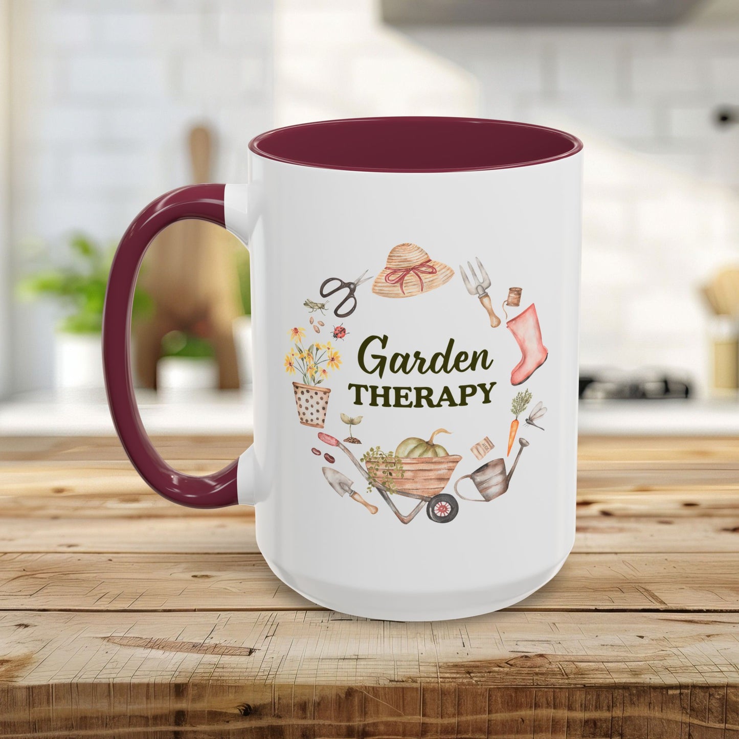 White ceramic mug with a maroon handle and interior, featuring a "Garden Therapy" wreath design.