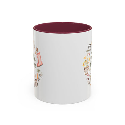 White ceramic mug with a maroon interior and "Garden Therapy" text surrounded by watercolor garden tools.