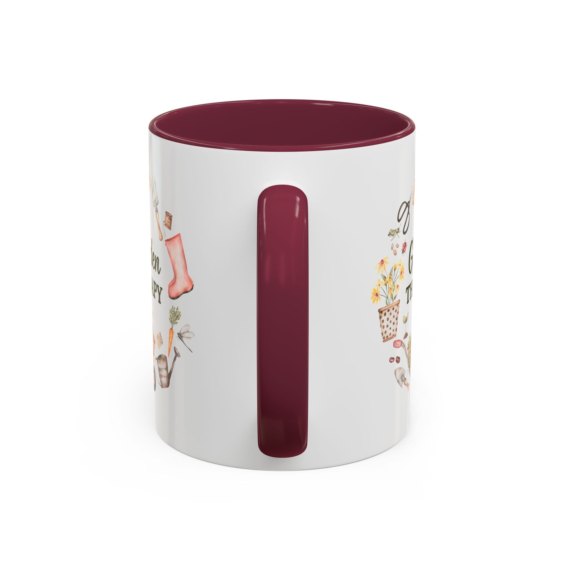 White ceramic 11oz mug with a maroon handle and interior, featuring a "Garden Therapy" floral wreath design.