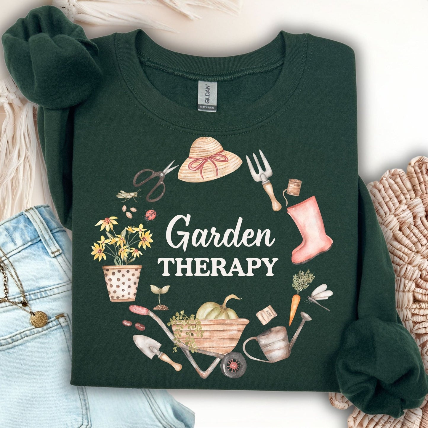 Forest Green Garden Therapy sweatshirt with a floral wreath of gardening tools, boots, and seed packets.
