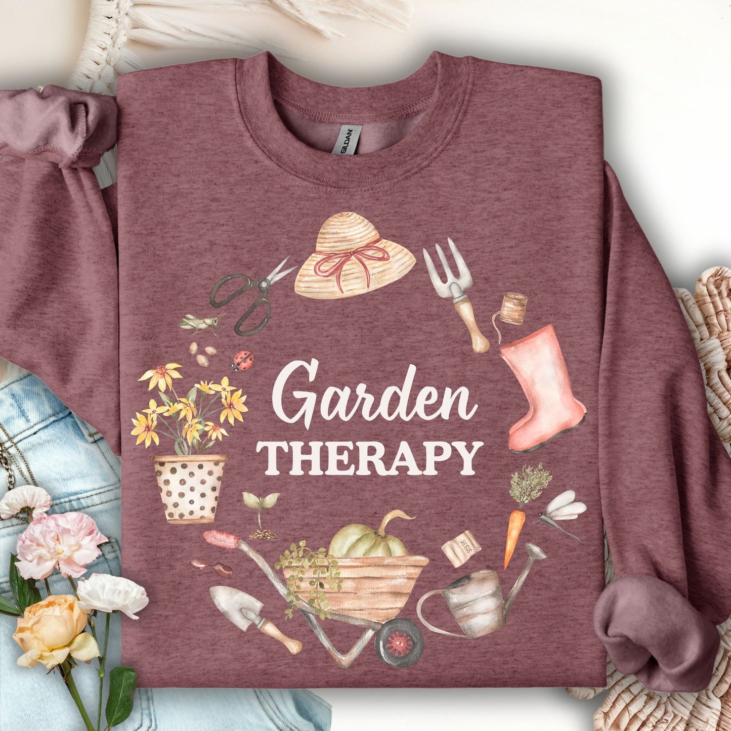 Heather Sport Dark Maroon sweatshirt with "Garden Therapy" text surrounded by a floral wreath of gardening tools.