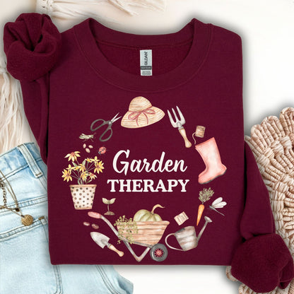 Maroon unisex sweatshirt with "Garden Therapy" text surrounded by a floral wreath of gardening tools.