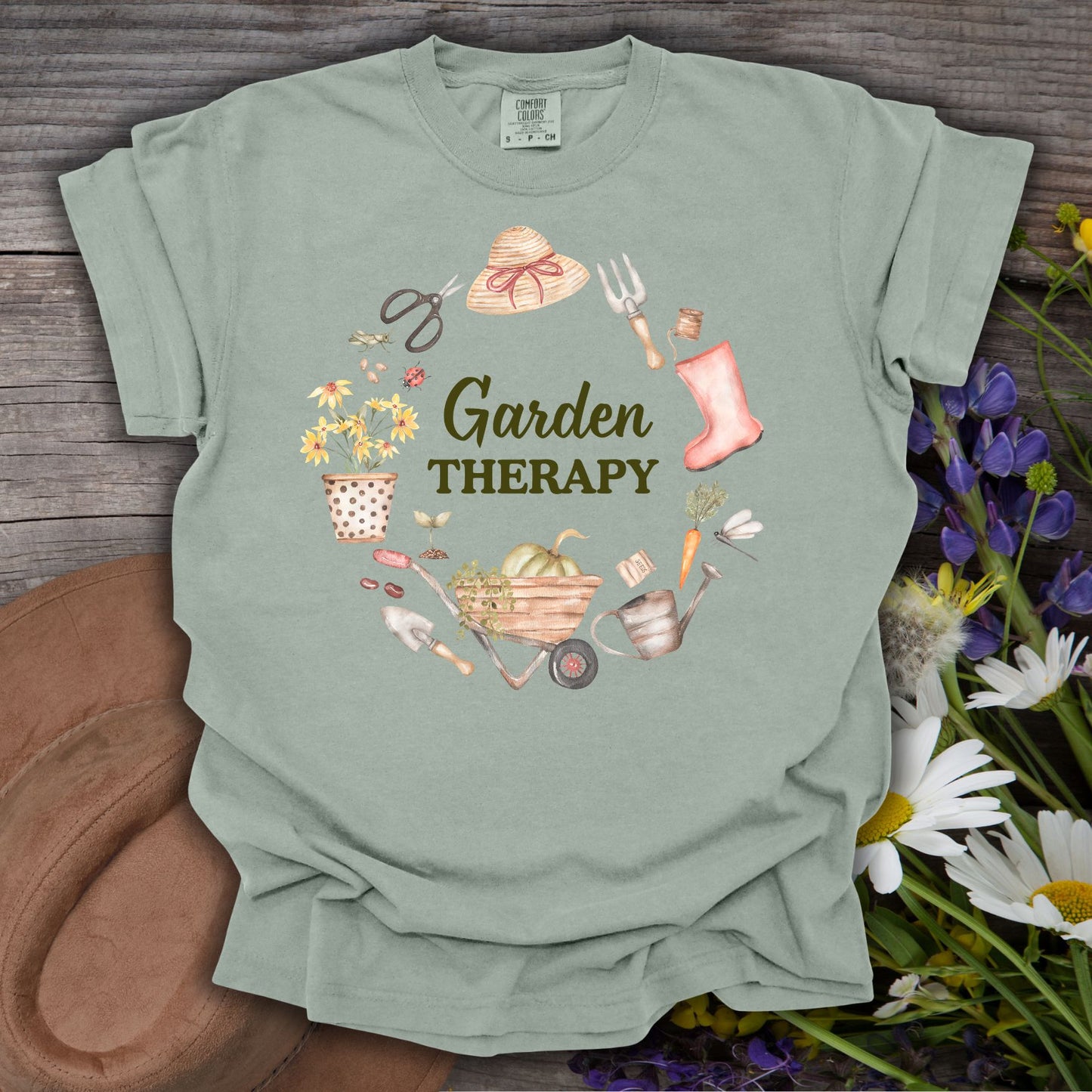 Bay green, relaxed-fit cotton t-shirt with "Garden Therapy" in a floral wreath of garden tools.