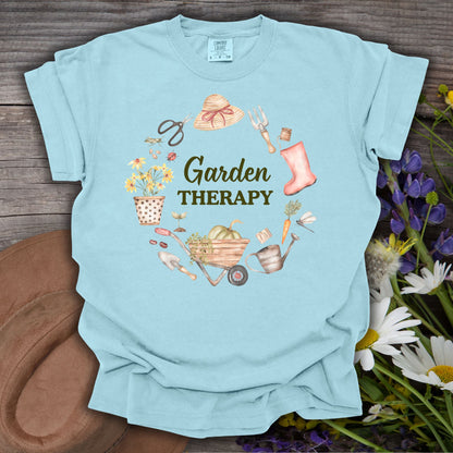 Chambray blue garment-dyed cotton t-shirt with "Garden Therapy" surrounded by watercolor garden tools and flowers.