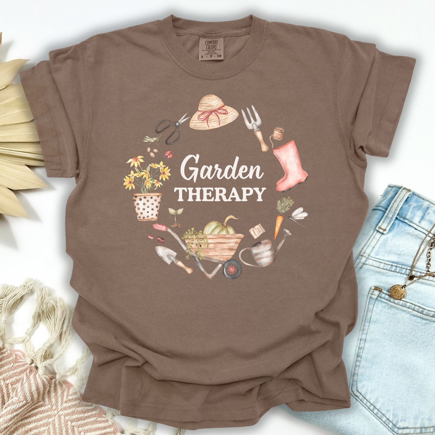 Espresso S t-shirt with "Garden Therapy" in a floral wreath of gardening tools, hat, boots, and blooms.