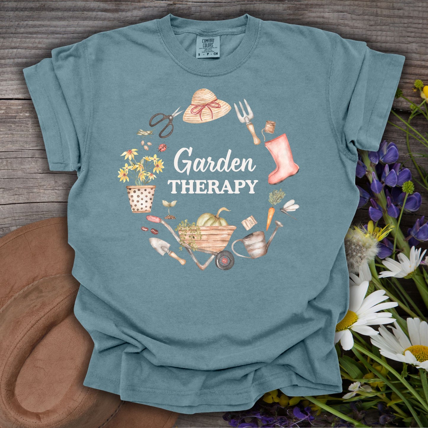 Ice Blue S t-shirt with "Garden Therapy" in a floral wreath of garden tools, hat, boots, and wheelbarrow.