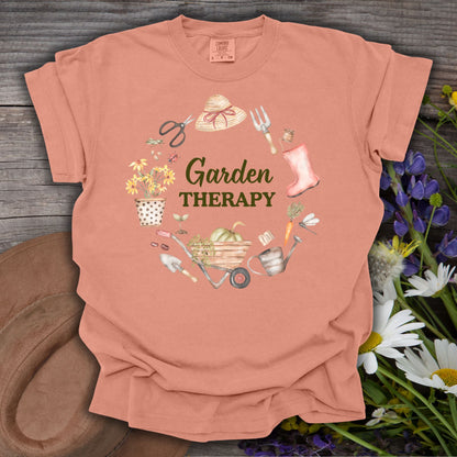 Terracotta S t-shirt with "Garden Therapy" in a wreath of gardening tools, hat, boots, and blooms.