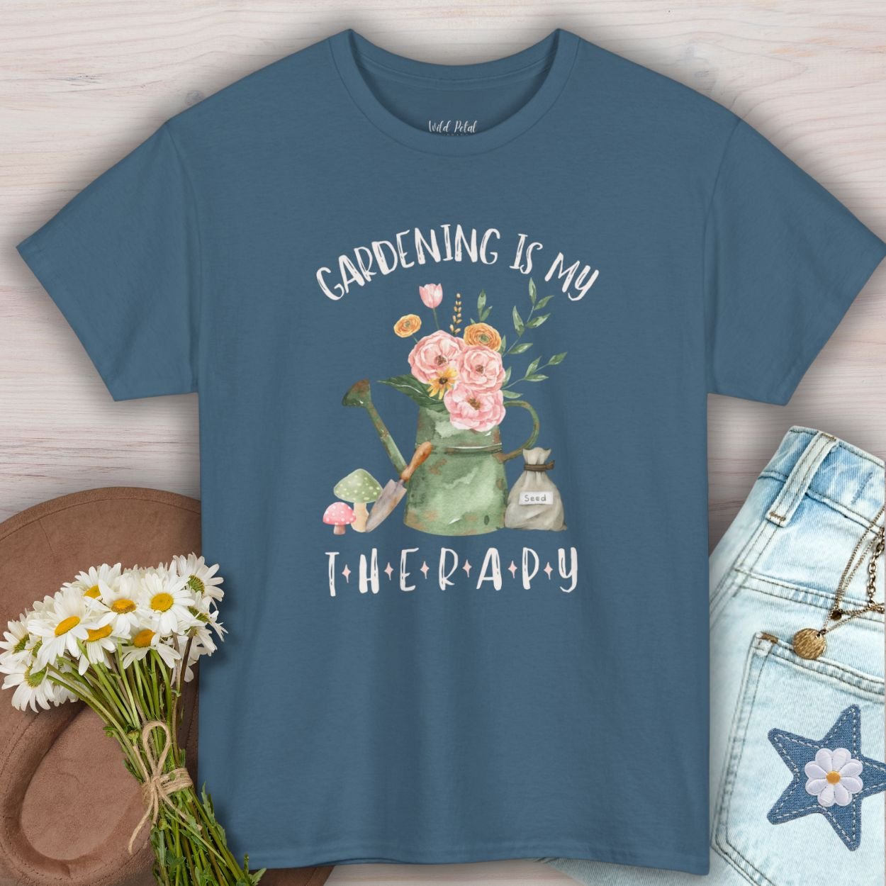 Indigo blue cotton tee with "Gardening Is My Therapy" text and watercolor watering can, flowers, and trowel design.