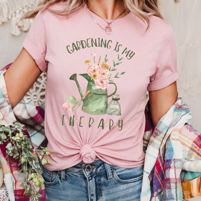 woman wearing a pink t-shirt with 'Gardening is my Therapy' graphic design.