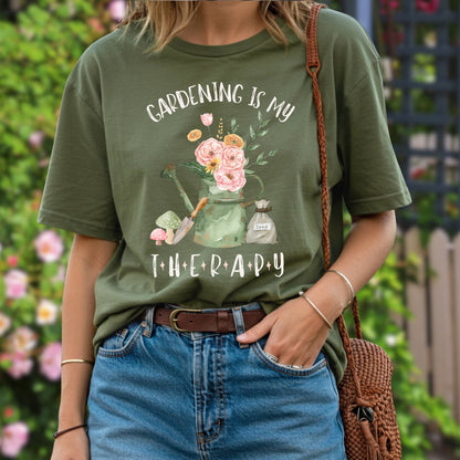 Person wearing a green t-shirt with 'Gardening is my therapy' design, standing outdoors.