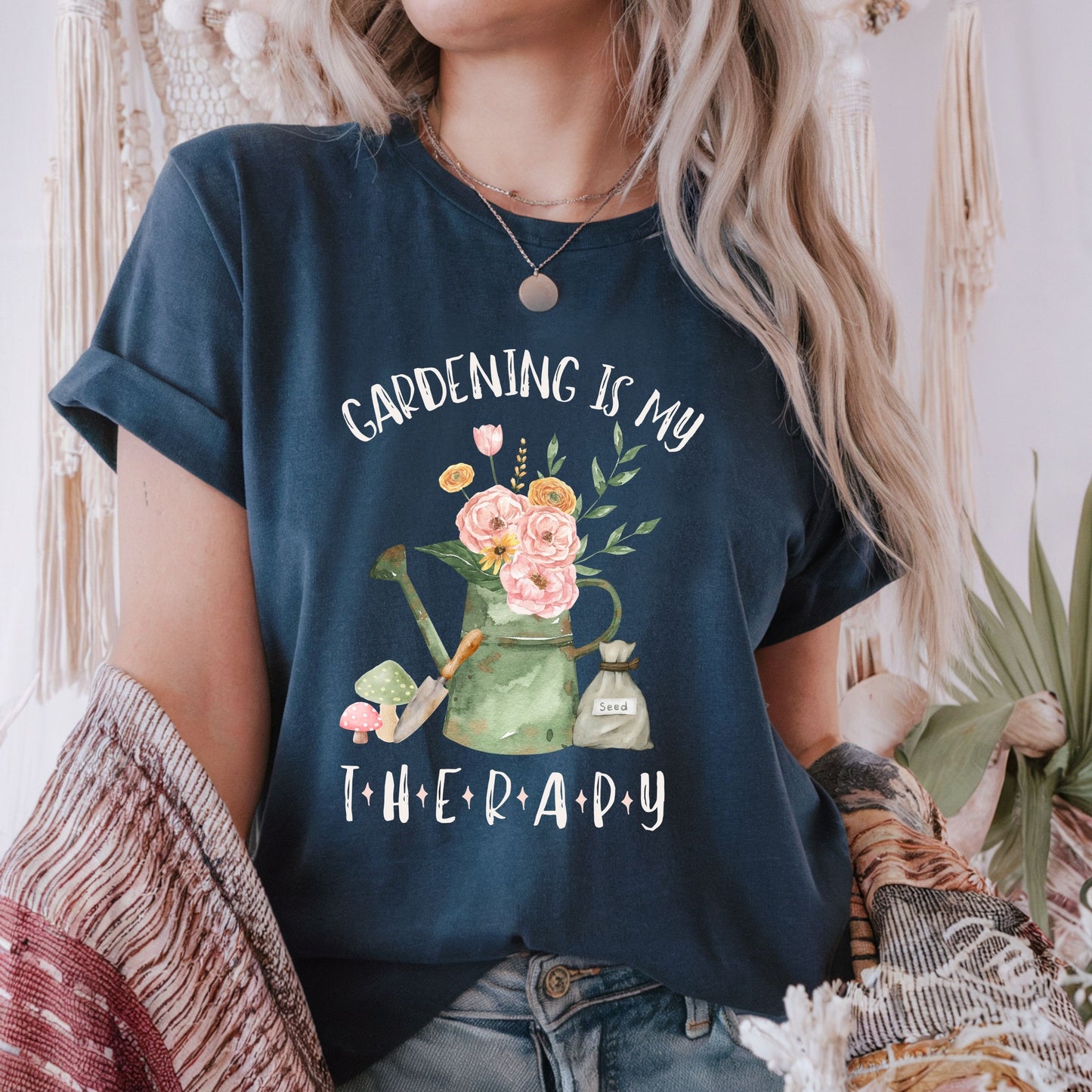 Person wearing a navy blue t-shirt with 'Gardening is my Therapy' design.