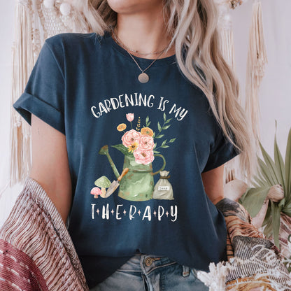 Person wearing a navy blue t-shirt with 'Gardening is my Therapy' design.
