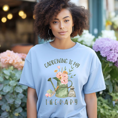 Woman wearing a light blue t-shirt with 'Gardening is my Therapy' design in a garden setting