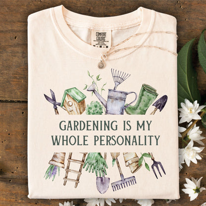Ivory Comfort Colors t-shirt with "Gardening Is My Whole Personality" text and watercolor gardening tools.