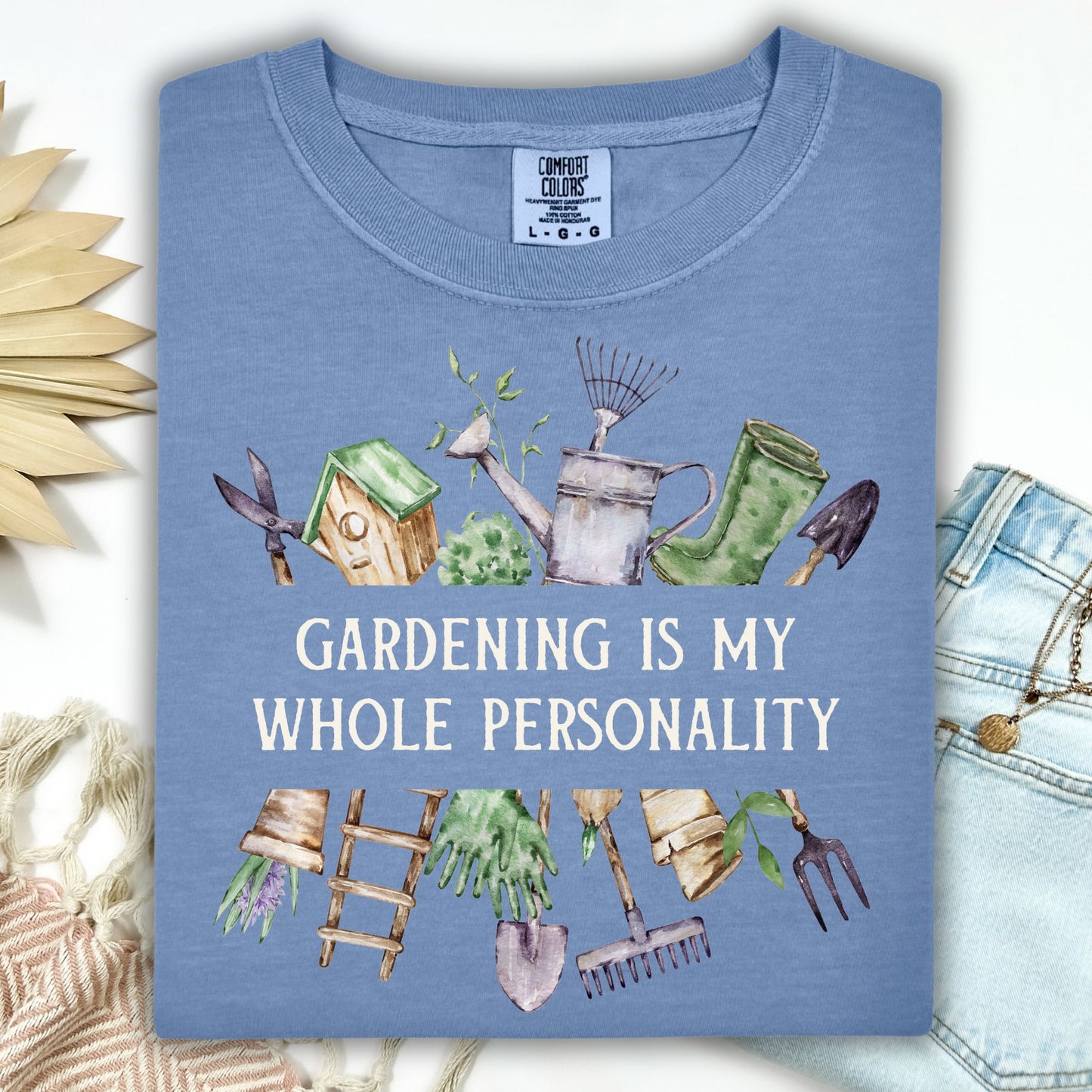 Blue Jean Comfort Colors t-shirt with "Gardening Is My Whole Personality" text and watercolor gardening tools.