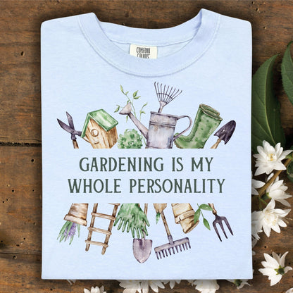 Light blue Comfort Colors t-shirt with "Gardening Is My Whole Personality" text and watercolor gardening tools.