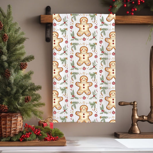 Microfiber tea towel with a repeating gingerbread cookie and holly pattern, hanging in a festive kitchen.