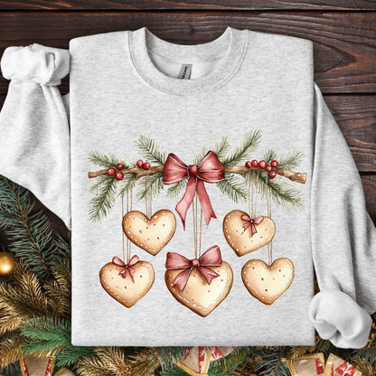 Ash gray sweatshirt with watercolor evergreen garland and hanging gingerbread heart cookies.