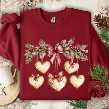 Cardinal Red sweatshirt with watercolor evergreen garland and hanging gingerbread heart cookies.