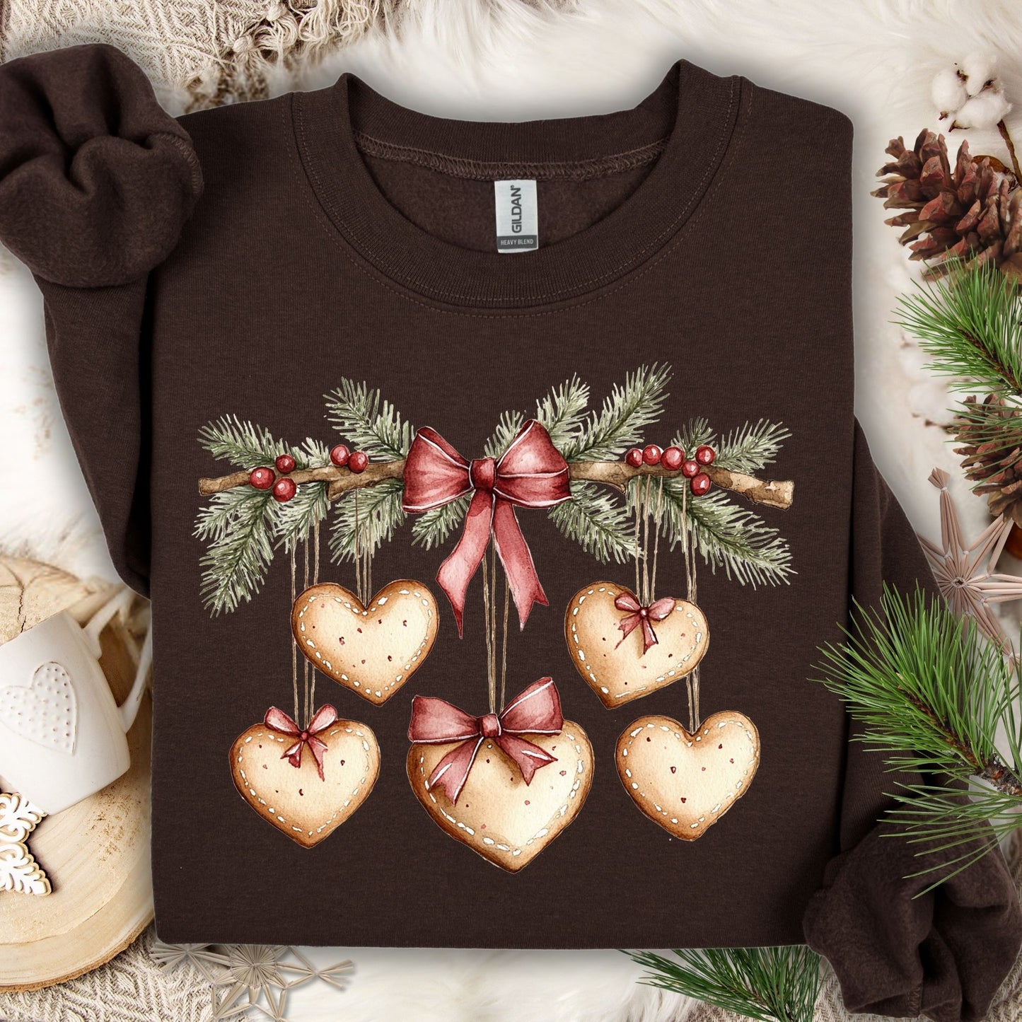 Dark chocolate Gildan sweatshirt with watercolor gingerbread heart garland design.