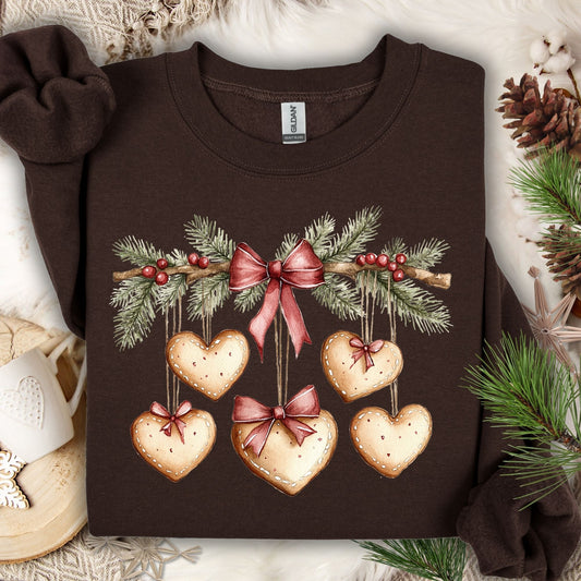 Dark chocolate Gildan sweatshirt with watercolor gingerbread heart garland design.