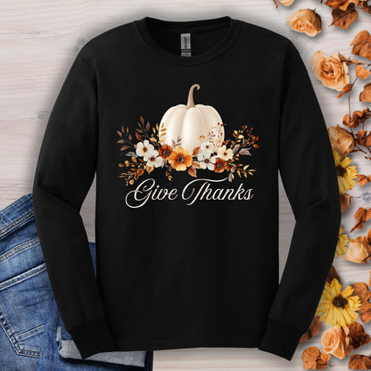 Black Gildan long sleeve tee with a white pumpkin, autumn foliage, wildflowers, and "Give Thanks" text.