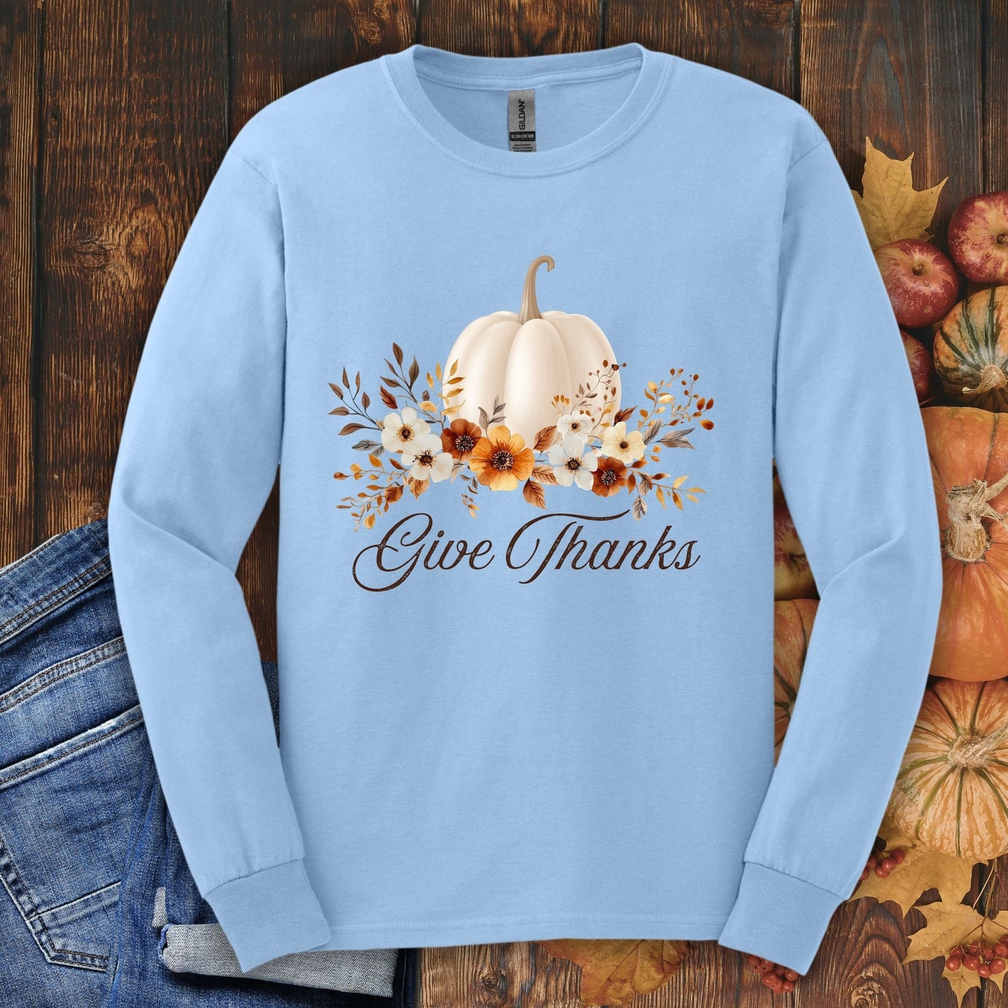 Light blue Gildan long sleeve tee, size S, with a watercolor white pumpkin, autumn foliage, and "Give Thanks" text.