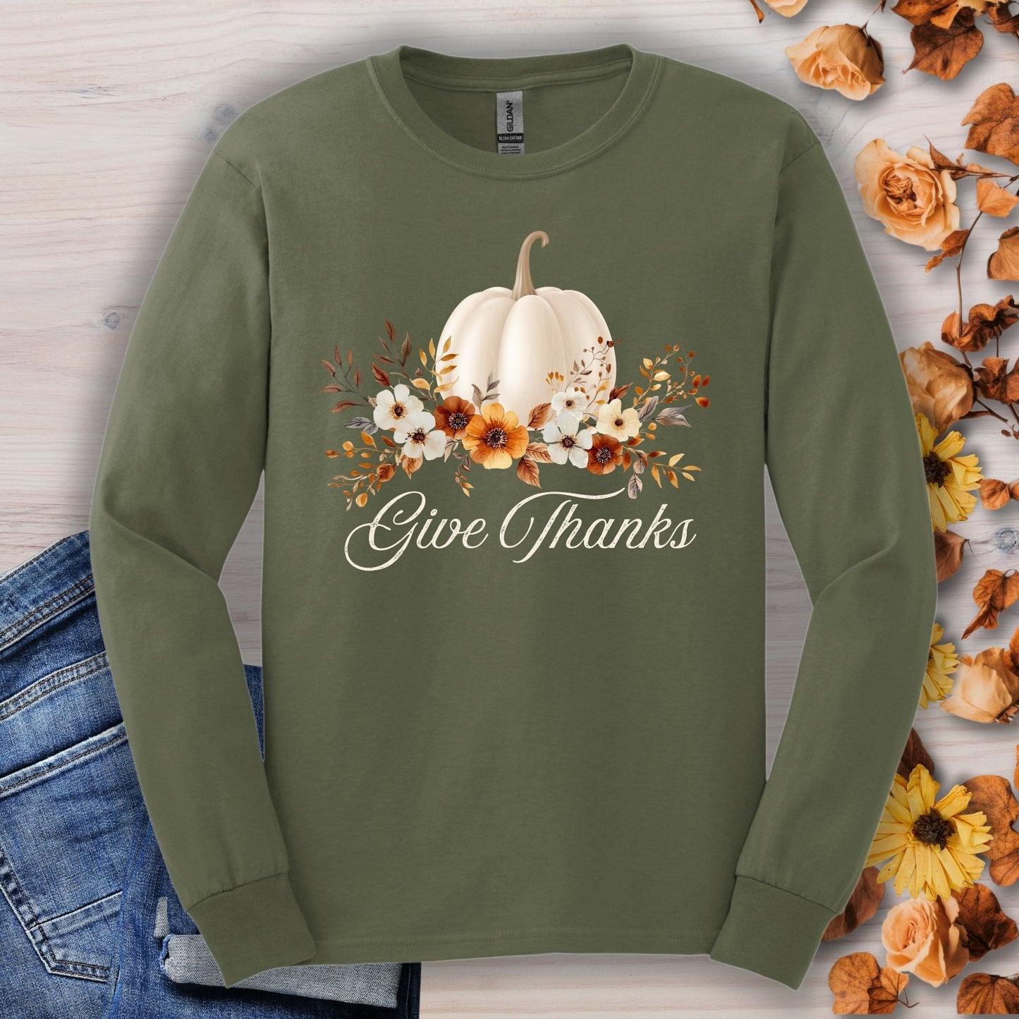 Military Green Gildan long sleeve tee with a white watercolor pumpkin, autumn foliage, and "Give Thanks" text.