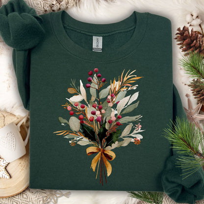 Forest green sweatshirt with a watercolor Christmas bouquet of berries, eucalyptus, and evergreens tied with a golden bow.