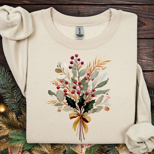 Sand Gold Holiday Bouquet Sweatshirt with watercolor berries, eucalyptus, and evergreen sprigs tied with a golden bow.
