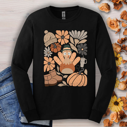 Black long sleeve tee with a groovy turkey, boots, pumpkin, hat, and fall flowers graphic.