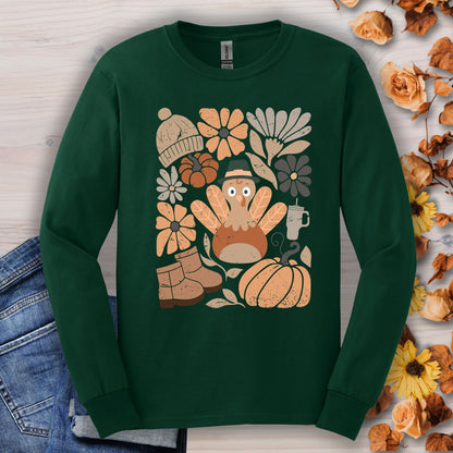 Forest Green long sleeve tee with a "Groovy Turkey" graphic surrounded by fall essentials like boots, pumpkins, and flowers.