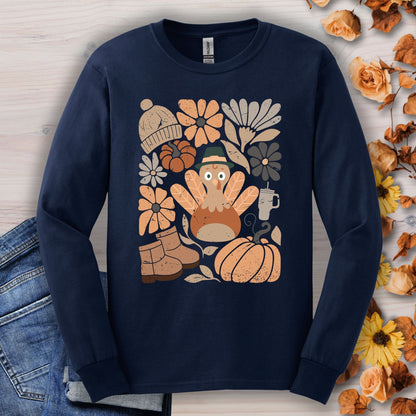 Navy long sleeve tee with a "Groovy Turkey" graphic surrounded by fall boots, leaves, and flowers.