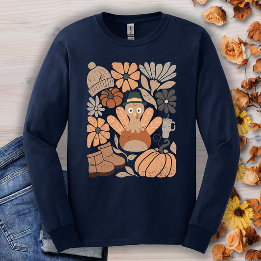 Navy long sleeve tee with a "Groovy Turkey" graphic surrounded by fall boots, leaves, and flowers.