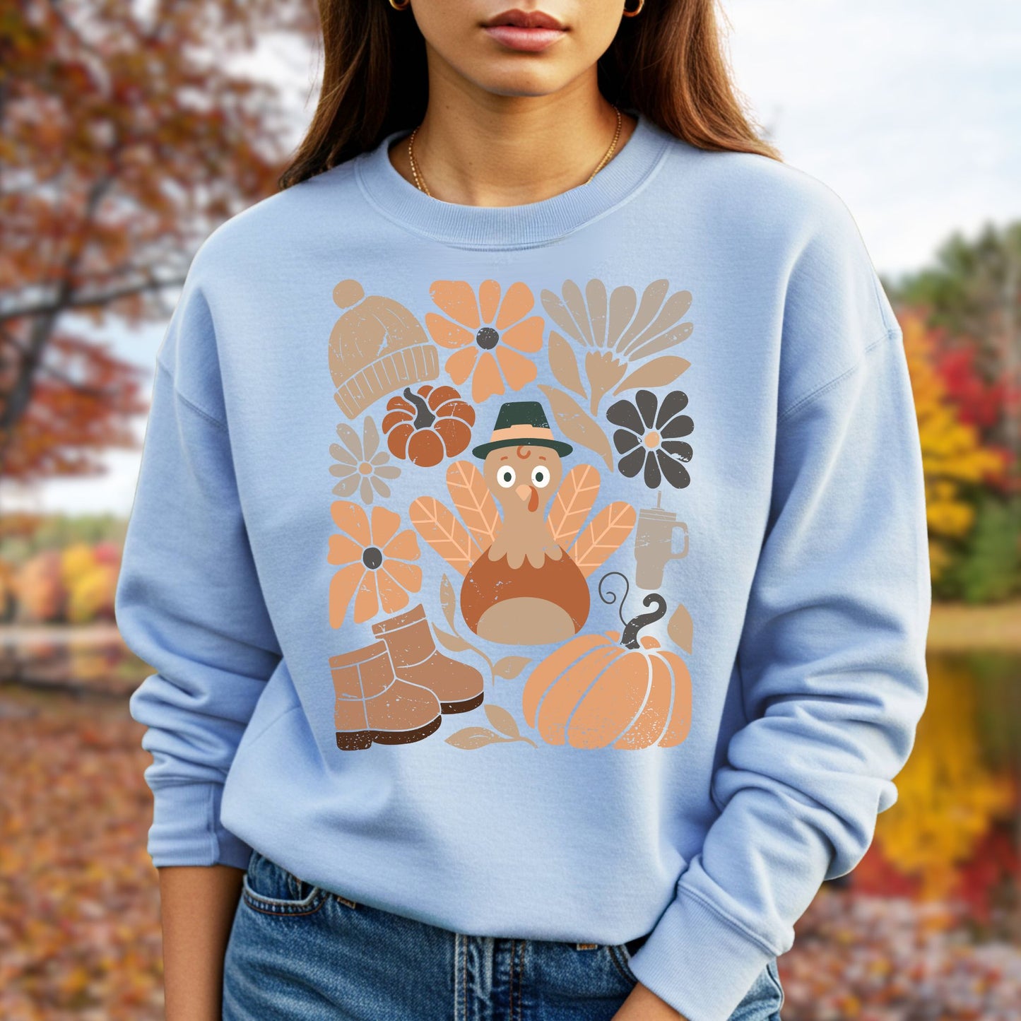 Light blue Gildan 18000 sweatshirt with a groovy turkey, fall leaves, boots, and pumpkins.