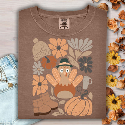 Espresso Comfort Colors t-shirt with a groovy turkey, fall flowers, pumpkin, boots, and hat graphic.