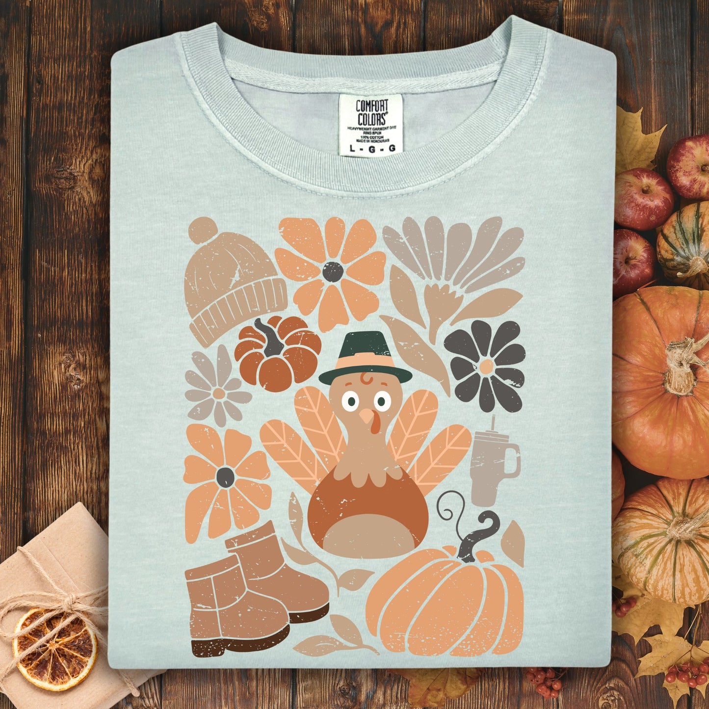 Bay Comfort Colors t-shirt with a groovy turkey, pumpkins, boots, and autumn flowers design.