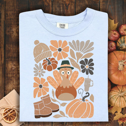 Hydrangea Comfort Colors t-shirt with a groovy turkey, pumpkins, flowers, boots, and hat.