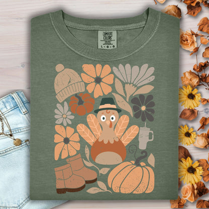 Moss green Comfort Colors t-shirt with a groovy turkey, pumpkins, boots, hat, and fall flowers.