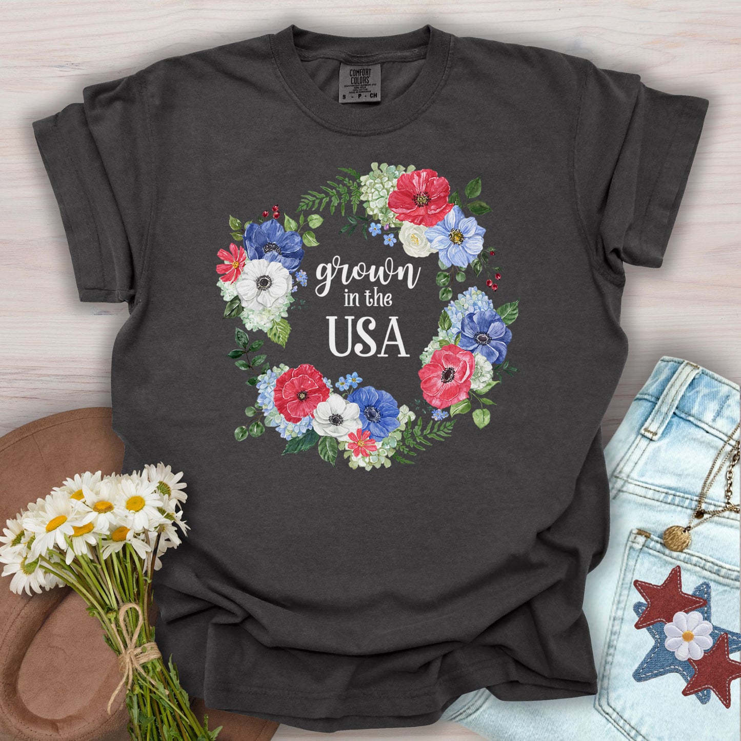 Pepper S-size t-shirt with "Grown in the USA" in a watercolor floral wreath of red, white, and blue blooms.