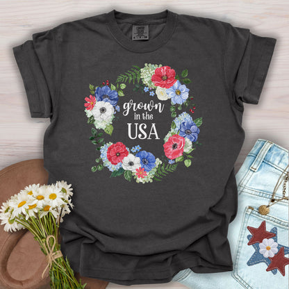 Pepper S-size t-shirt with "Grown in the USA" in a watercolor floral wreath of red, white, and blue blooms.