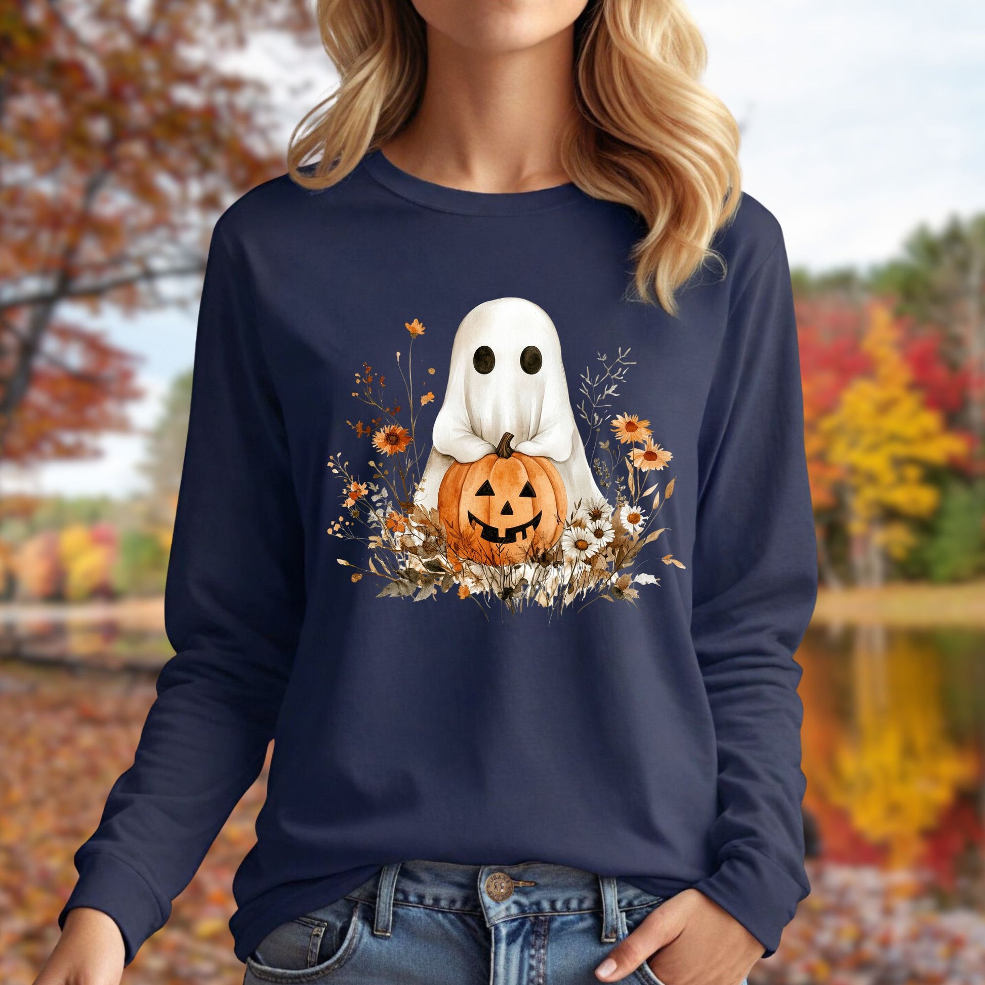 Navy long sleeve tee with a boho ghost holding a pumpkin, surrounded by earthy florals.