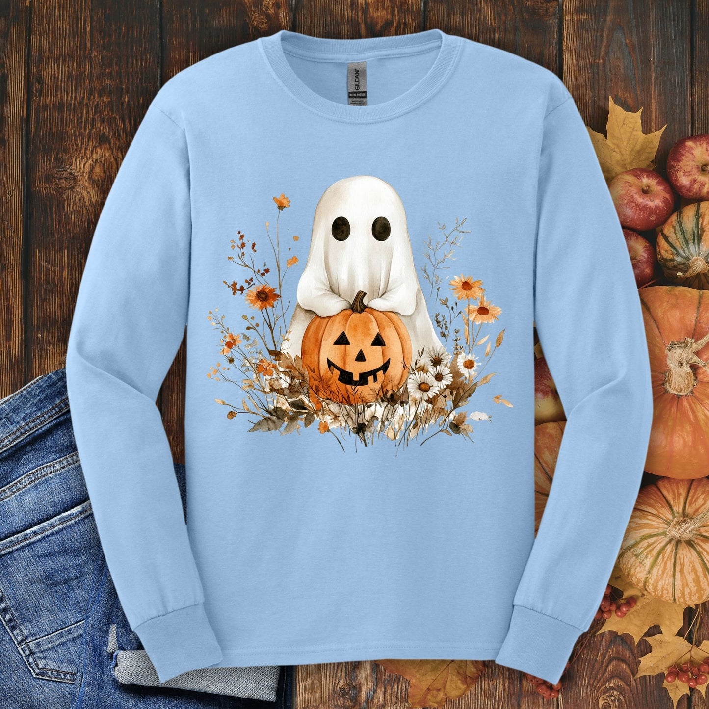 Light blue long-sleeve tee with a boho ghost holding a pumpkin, surrounded by fall florals.