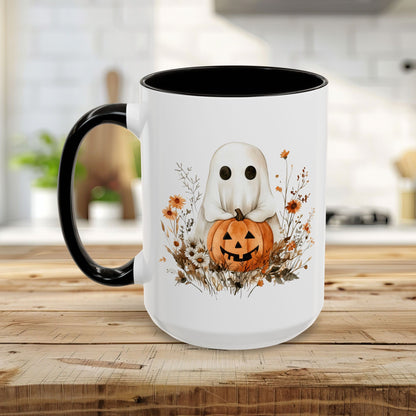 White ceramic mug with black handle and interior, featuring a watercolor ghost holding a jack o'lantern amidst wildflowers.