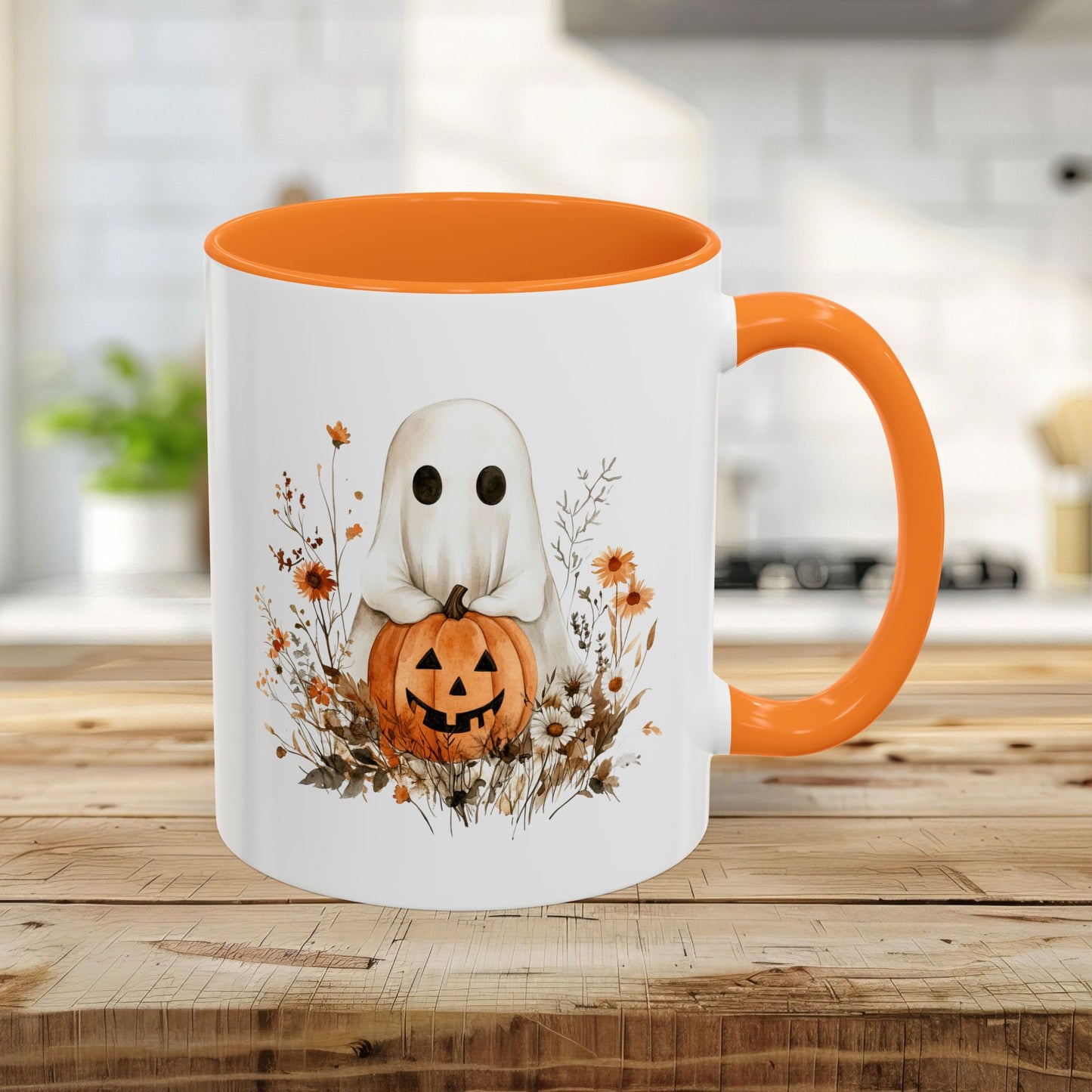 White 11oz ceramic mug with orange handle and interior, featuring a watercolor ghost holding a jack-o'-lantern amidst wildflowers.